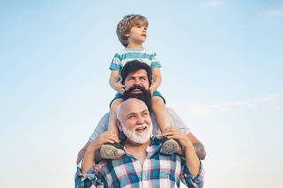 Men generation: grandfather father and grandson are hugging looking at camera and smiling. Fathers day concept. Generation concept. Weekend family play. Men in different ages.