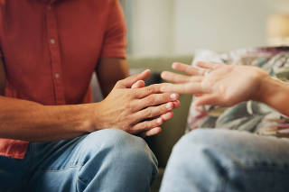 Couple, hands and living room with anxiety, stress and drama at home or apartment. Frustrated, woman and man with argument, angry and fight with toxic marriage and mistake or crisis with partner