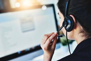 Managing the days inquiries. Rearview shot of a young woman working in a call centre.
